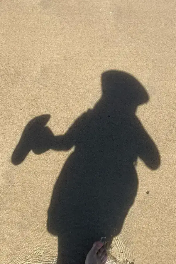 Shadow of a person on a beach